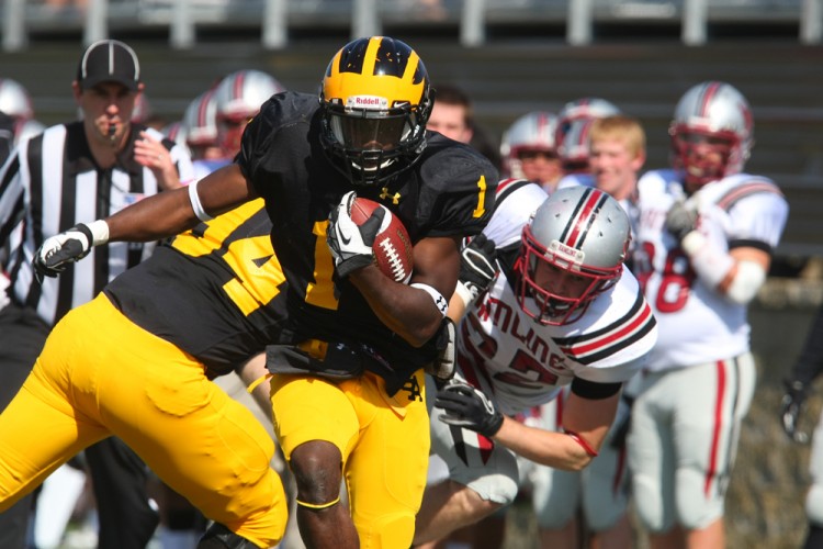 Phillip Butler runs through a tackle on Saturday against Hamline. The Gusties defeated the Pipers 37-0 for their first MIAC victory of the season. Photo courtesy of Bridget Fowler - Sport PiX.