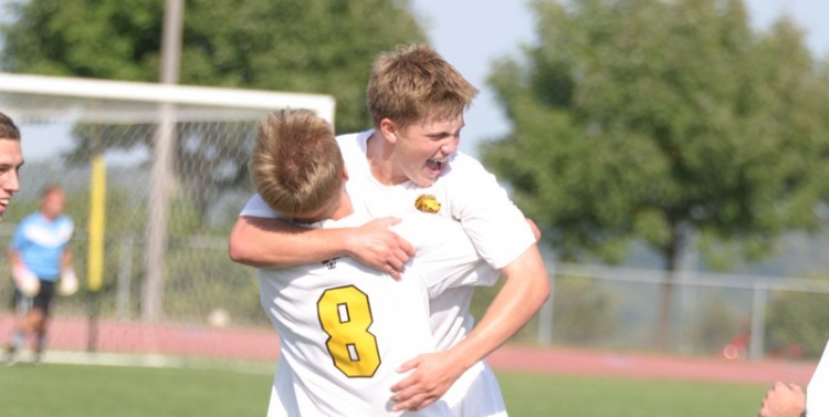 Freshman Charlie Adams celebrates with teammate David Lilly after his game-tying goal at the end of regulation.