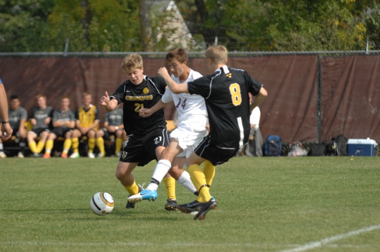 Gustavus' Charlie Adams and David Lilly converge on Concordia's Michael Forston Saturday afternoon in Moorhead.  Photo courtesy of Jim Cella - Concordia Sports Information Director