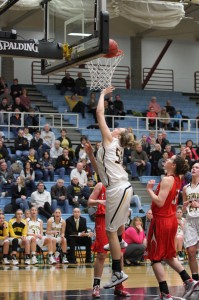 Karina Schroeder goes up for a layup over a pair of Saint Ben's posts. 