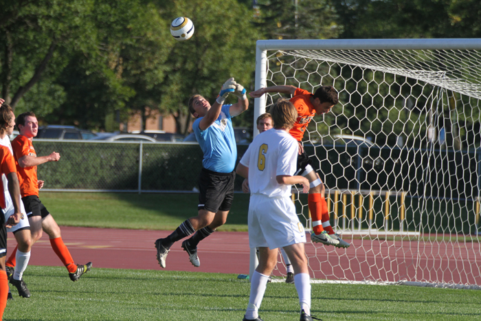 Goalkeeper Brett Ylonen leaps up to clear a cross away from an attacking Wartburg player.  Gustavus suffered a 2-1 loss to the Knights on Tuesday afternoon.