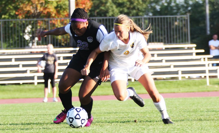 Amanda Cartony battles Crown defender Sabrina Holley in Wednesday's win. (Photo courtesy of Andrew Vold `15)