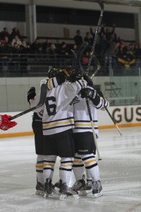 Tyler Lapic celebrates his game-winning goal with his teammates. 