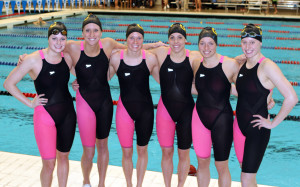 The six Gustie female swimmers get together for one last picture in their pink suits with senior Laura Drake who swam her final race this morning. 