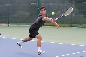 Motasem Al-Houni extends with his backhand to keep a point alive at No. 5 singles. Photo courtesy of Morgan Stock - Sport PiX.