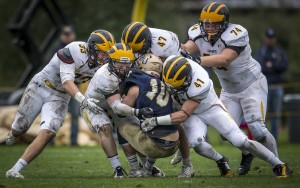The Gustie defense makes a gang tackle. (photo by Tim Kruse)
