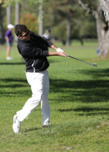 Max Savini bends his approach shot around a tree and on to the green.